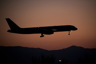 Aircraft approaching Dalaman Airport at dusk