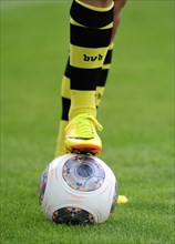 Legs of a BVB player with an Adidas Torfabrik league ball