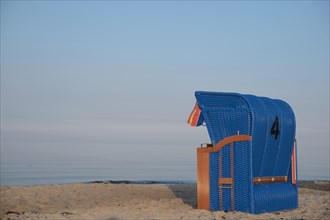 Blue roofed wicker beach chair on a beach