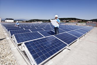 Two technicians inspecting a solar energy plant