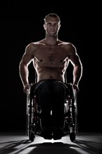 Muscular wheelchair user with a bare chest