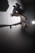 Freerunner jumping and turning off a wall