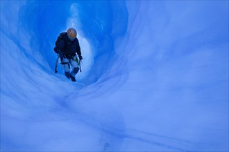 Ice climbing in an ice cave or glacier cave