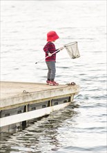 Child standing on jetty