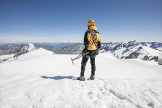Mountaineer standing on the summit of Mt Schwarzenstein