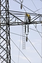 High voltage technician installing a new high-voltage power line