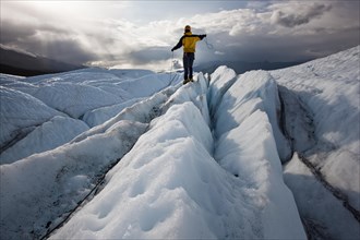 Mountaineer standing on Matanuska Glacier and pulling on a rope