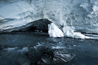 Glacial stream flowing through an ice cave of Matanuska Glacier