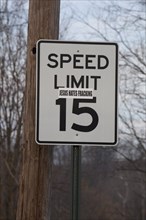 A sticker on a road sign near a natural gas well in the process of hydraulic fracturing or fracking in rural Lycoming County