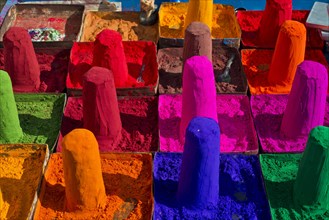 Colour powder for ritual purposes is displayed in small turrets for sale