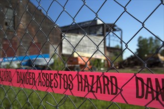 A warning of an asbestos hazard at the old Globe Trading Company building