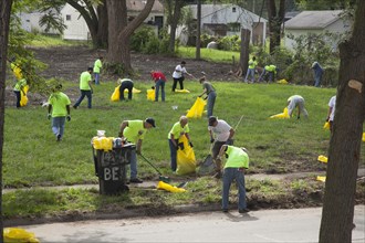 Volunteers helping the nonprofit Detroit Blight Authority cleaning up in the Brightmoor neighborhood