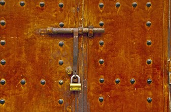 Lock and bar on an old metal door