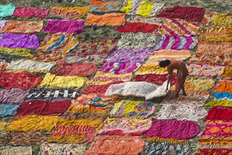 Colourful saris spread out to dry