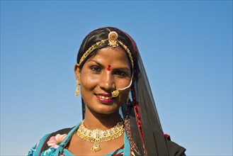 Smiling young Indian woman with a headscarf and jewellery