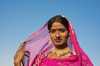Young Indian woman with pink scarf and jewellery