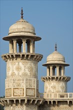 Towers with intricate marble inlays of an Islamic mausoleum