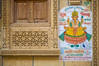 Decorated sandstone facade with a window opening and an effigy of the Hindu deity Ganesha