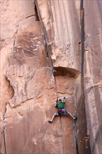 Rock climber climbing a rock wall