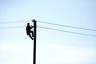 Man working on a power pole