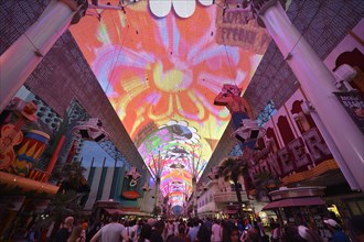 Tourists marvelling at the laser show in the neon dome of the Fremont Street Experience in old Las Vegas