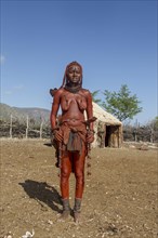 Young Himba woman standing in her village