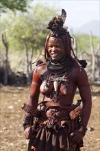 Young married Himba woman in traditional costume and headdress