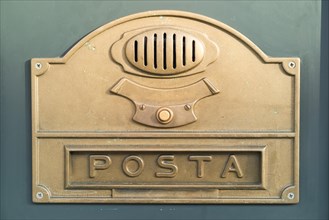 Brass plate with a doorbell button and a letter box