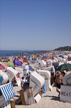 Roofed wicker beach chairs on a beach