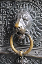 Lion head door knocker on the entrance portal