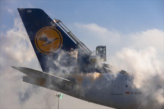 Tail unit of an Airbus A340 of Lufthansa airlines during de-icing at Frankfurt Airport