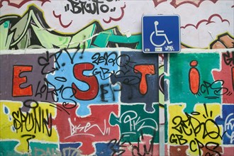 Sign Parking for disabled and wall covered with graffiti