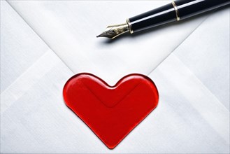 Love letter with a heart and a fountain pen