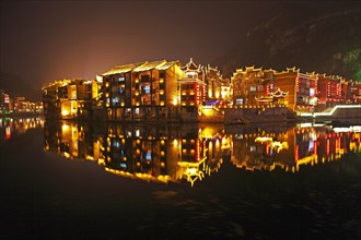 Illuminated houses on the Wuyang River at night