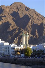 The corniche of Muttrah in front of the rocky mountains that surround the city at back