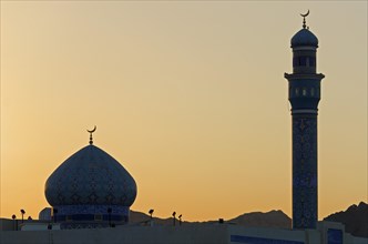 The back-lit minaret and dome of the Rasool Azam Mosque