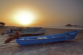 Sunset in Al Sawadi behind a couple of fishing boats