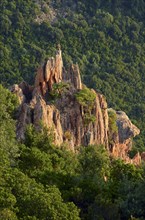 The typical bizarre red rocks of the Calanche of Pianasurrounded by green scrub. The Calanche of Piana is in the western part of the island Corsica