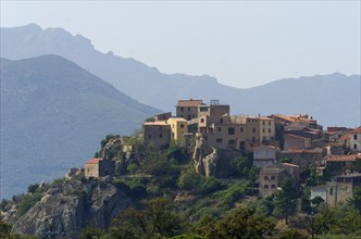 The small village of Montegrosso in front of the steep mountains of Corsica