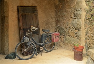 Old moped in front of a wall