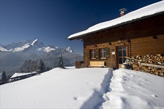 Wooden house on a snow-covered hill