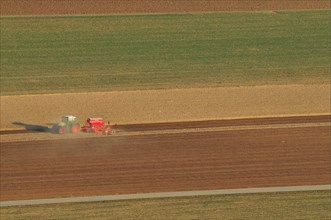 Tractor plowing fields in spring