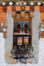 Prayer wheels in the outer wall of a temple