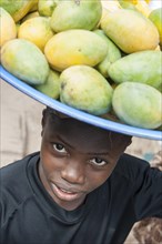 Young mango seller at a street market