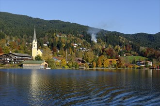 The town of Schliersee with the Church of St. Sixtus in autumn