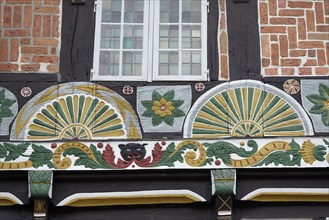 Half-timbered house with painted fan rosettes