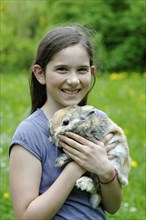 Girl holding a dwarf rabbit