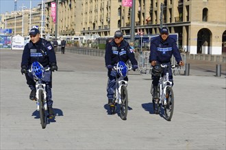 Policemen riding bicycles in the town centre, Marseille