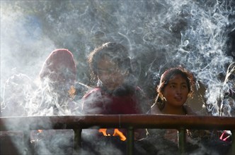 Pilgrims burning incense as an offering