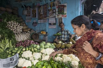 Local woman buying cauliflower at the market